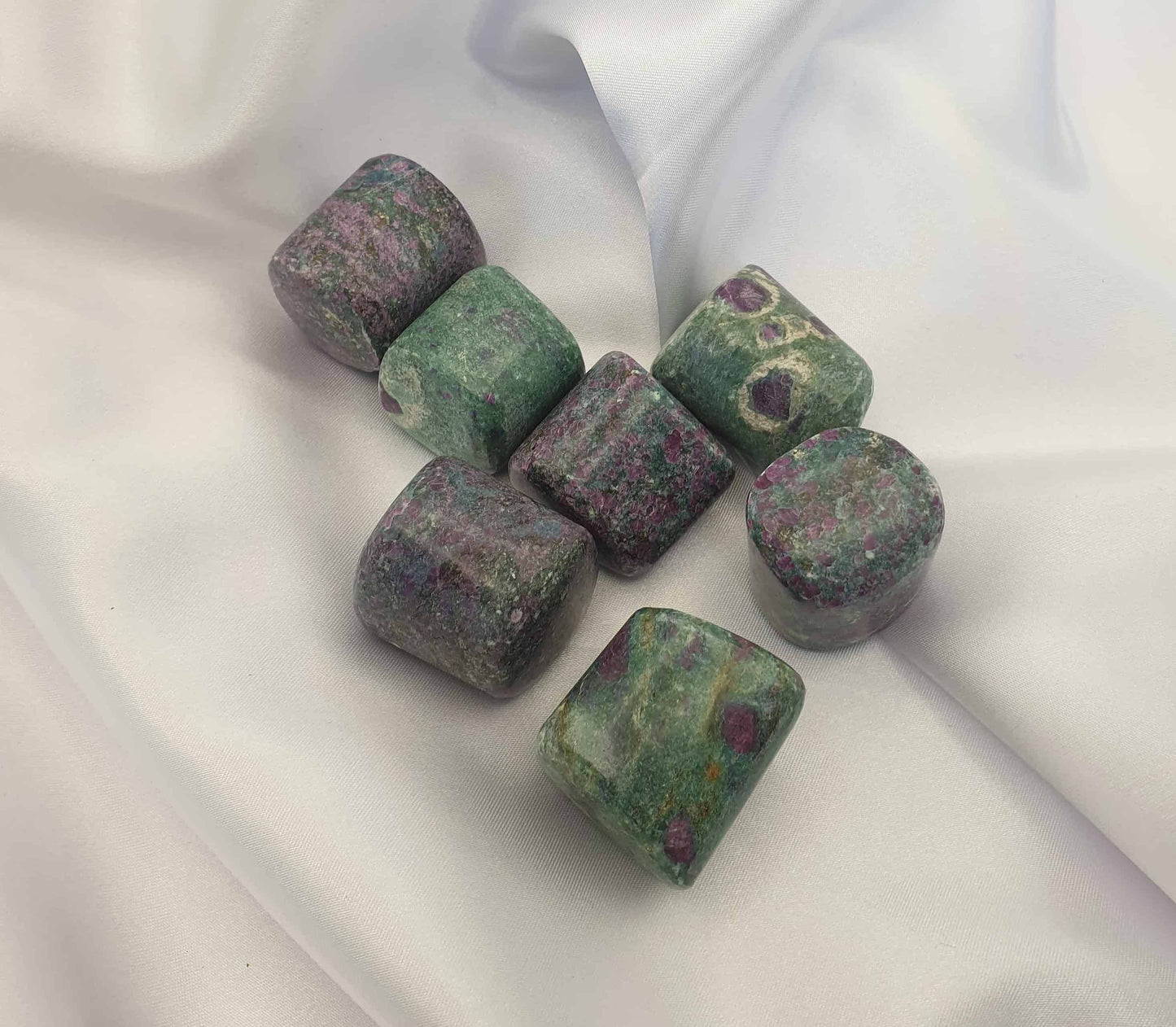 A combination of Ruby in Fuchsite, can offer a boost in strength and courage from the ruby and the relaxing properties of fuchsite.  A stone of the heart it can aid in self love and strength and fertility. Ruby fuchsite tumbled stones are handy to carry during times when emotional support is needed. Can help to release emotional baggage.