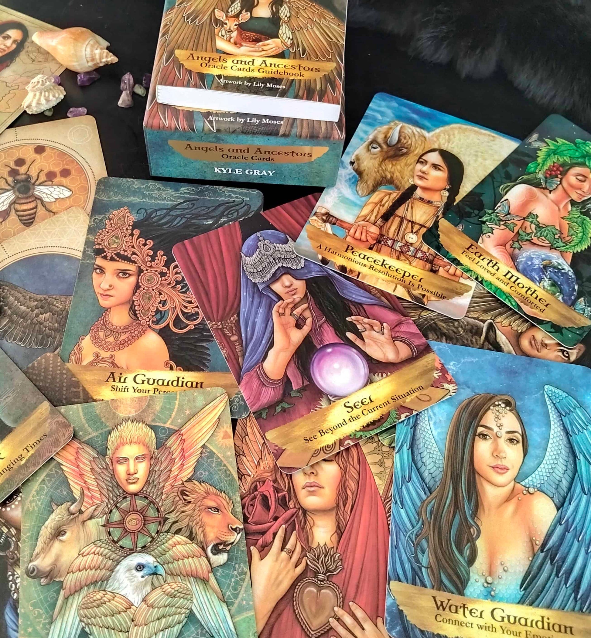Collection of tarot cards with various illustrations and text on a dark surface.