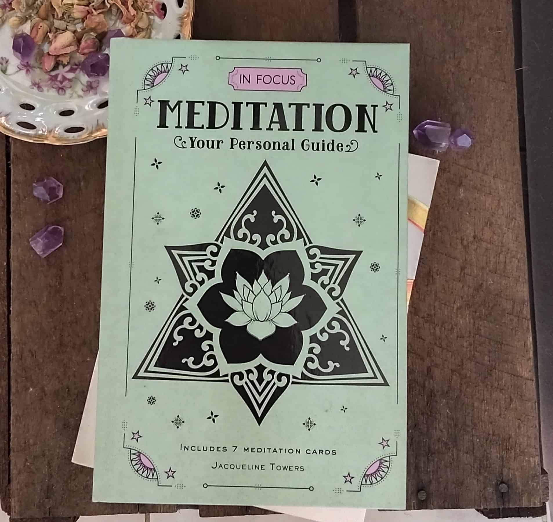 Meditation guidebook with star design on a wooden surface