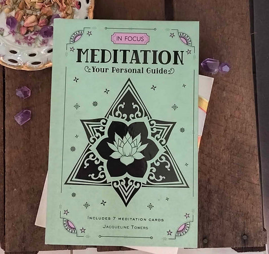 Meditation guidebook with star design on a wooden surface