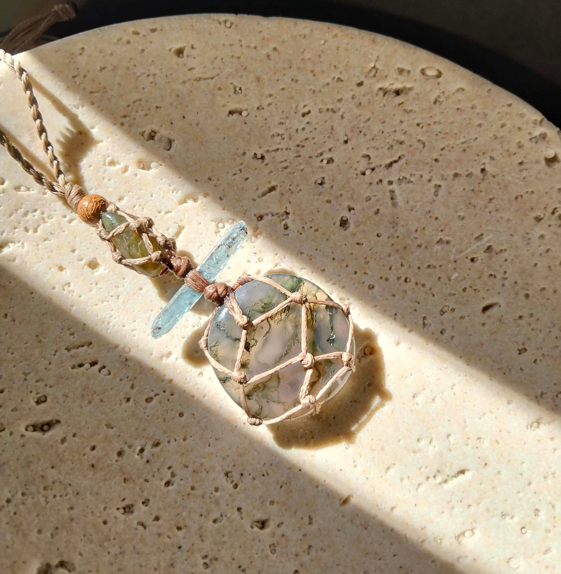 Talisman necklace with moss agate pale blue kyanite crystal and labradorite on a handmade twisted leather chord.