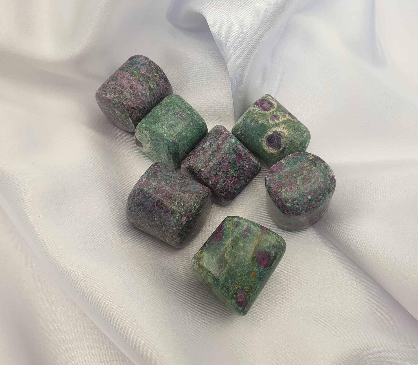 A combination of Ruby in Fuchsite, can offer a boost in strength and courage from the ruby and the relaxing properties of fuchsite.  A stone of the heart it can aid in self love and strength and fertility. Ruby fuchsite tumbled stones are handy to carry during times when emotional support is needed. Can help to release emotional baggage. 