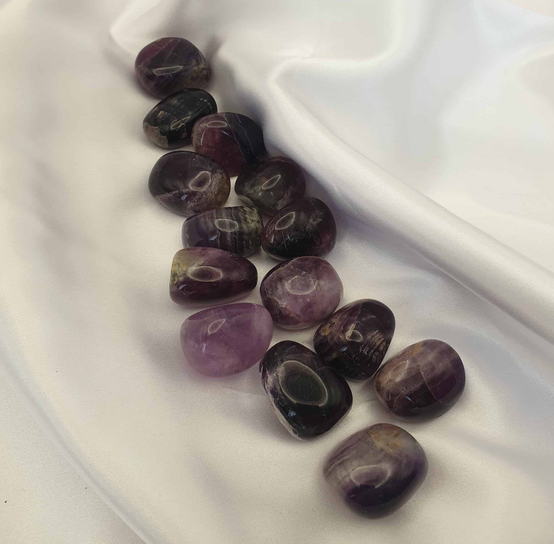 Purple Flourite is known to be a crystal of protection, whilst it can help with increased focus and deeper levels of thinking, so carrying a purple flourite tumbled stone may  help with creativity and being able to think outside the box.
