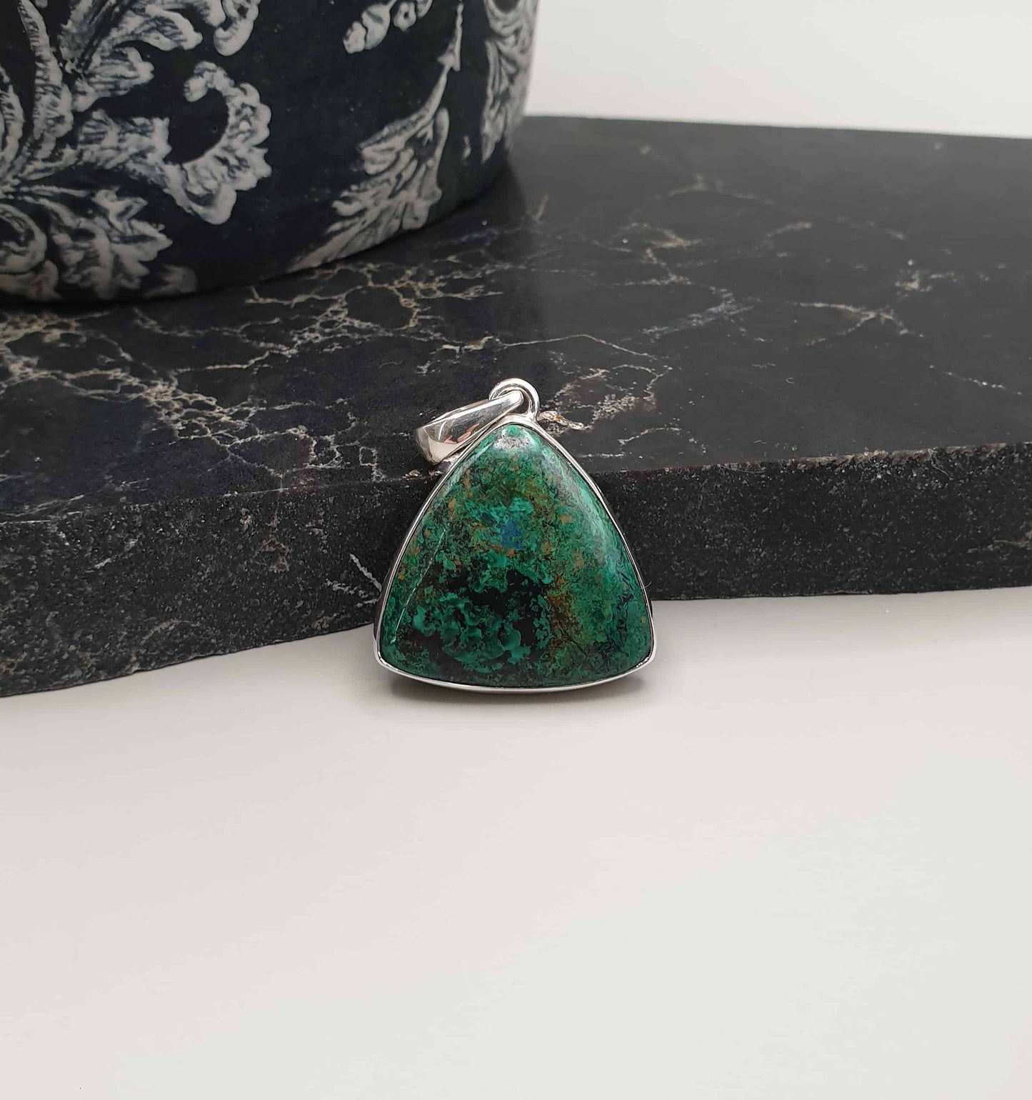 This Azurite Malachite Pendant is a strong combination, as these are considered to both be highly transformational stones which can assist with emotional balance and making peace with the past. It is also believed that Azurite Malachite can invite wealth and prosperity into your life.  Handcrafted in India using 925 sterling silver Gemstone is approximately 28mm in height & 29mm at widest point